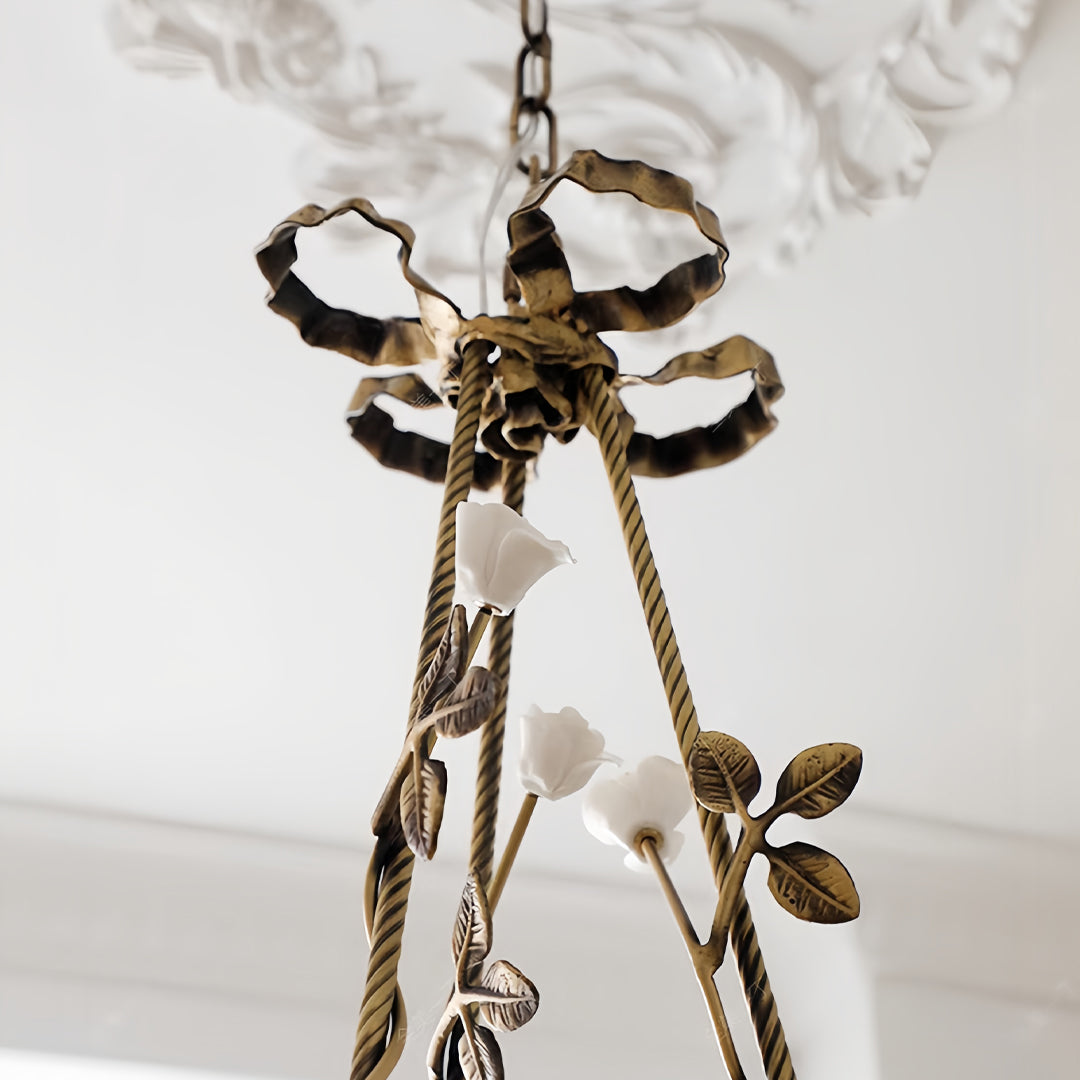 Detail view of modern flower chandelier highlighting decorative leaf elements and chain suspension hardware construction
