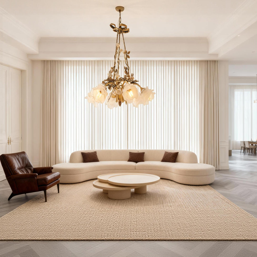 Modern flower chandelier illuminating minimalist living room with curved sofa and neutral color palette creating elegance