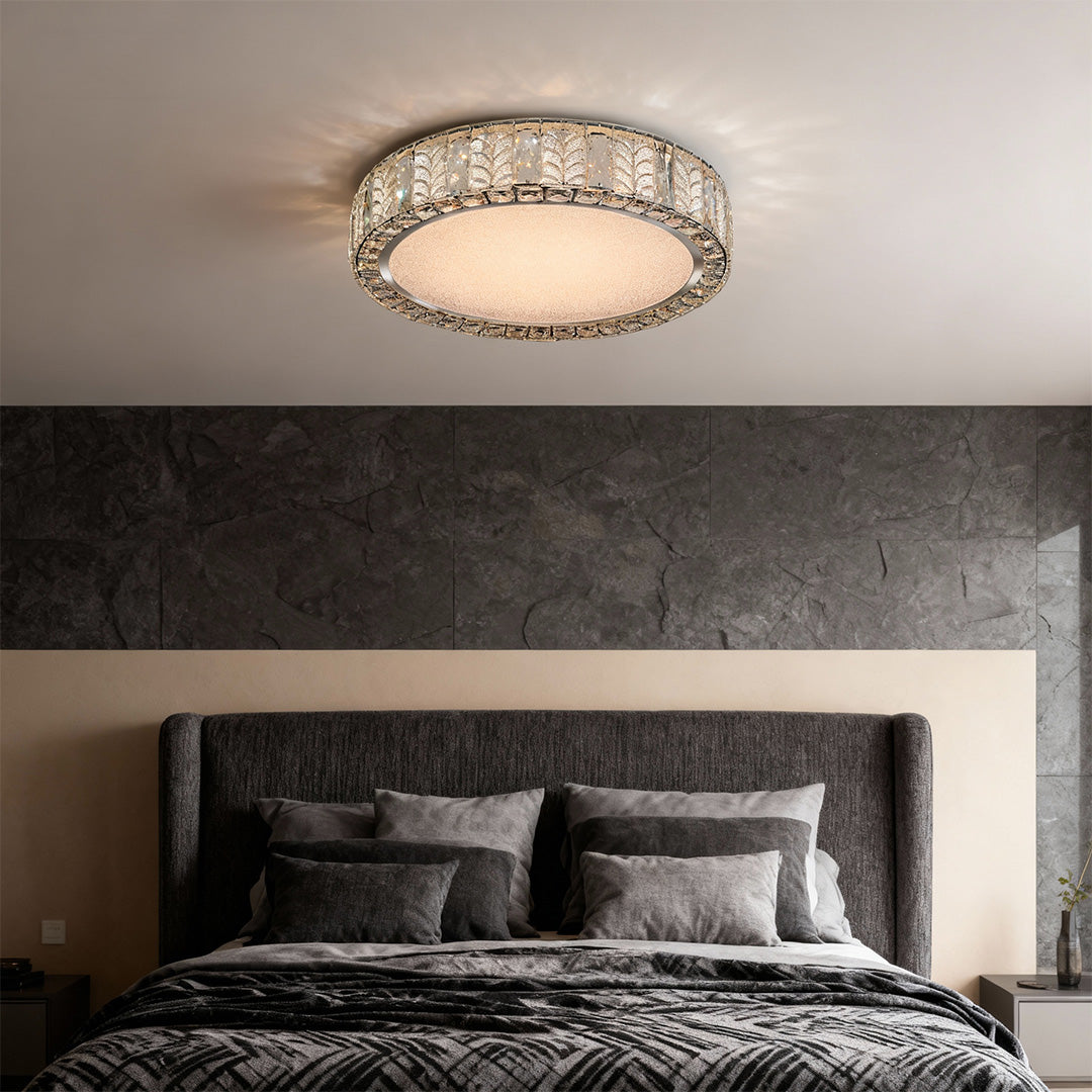 Modern flush mount ceiling light in a bedroom with large windows, adding a touch of elegance to the space.