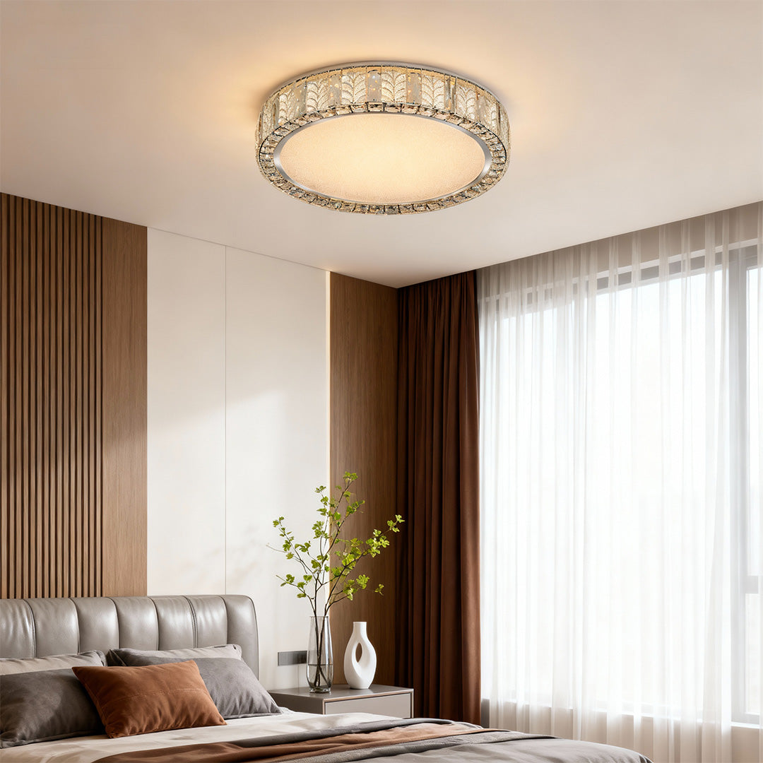 Modern flush mount ceiling light installed in a modern bedroom with a dark accent wall, providing warm and inviting illumination.