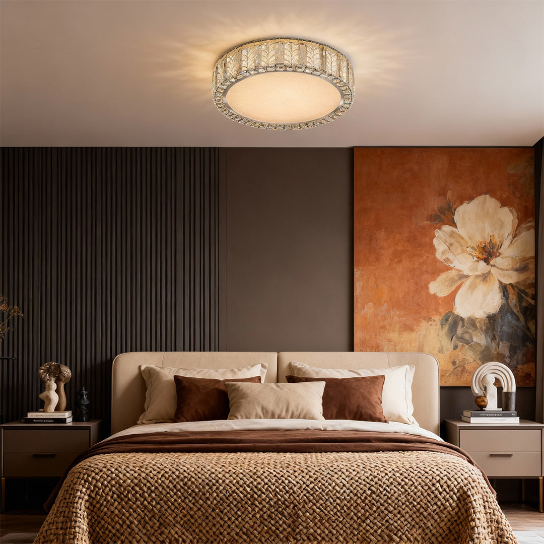 Modern flush mount ceiling light featuring a round shape with crystal accents and a metallic finish.