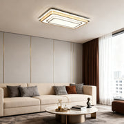 Modern flush mount light fixture illuminating a bright living room with minimalist design.