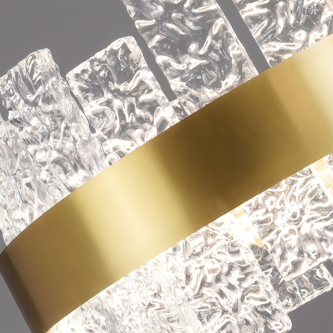 Modern luxury chandeliers close-up showcasing brass finish and textured crystal glass detail