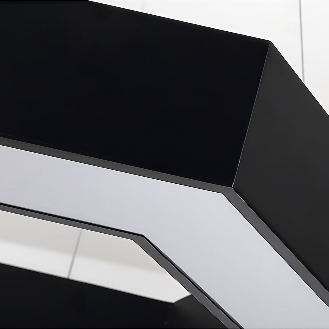 Close-up view of modern forms chandeliers showing sharp black geometric edges and integrated LED light panels.