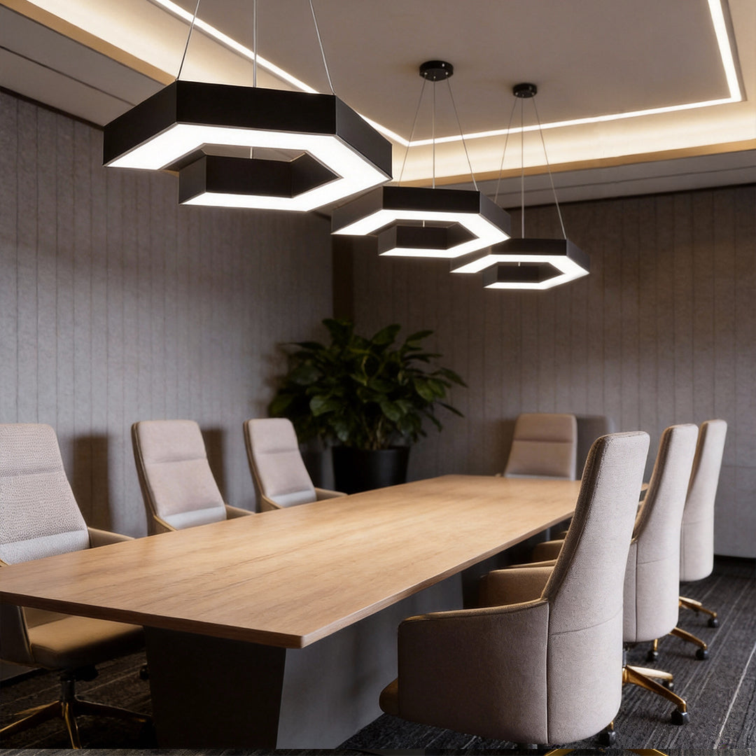 Modern forms chandeliers above a long meeting table, providing balanced LED lighting with bold geometric forms in a professional setting.