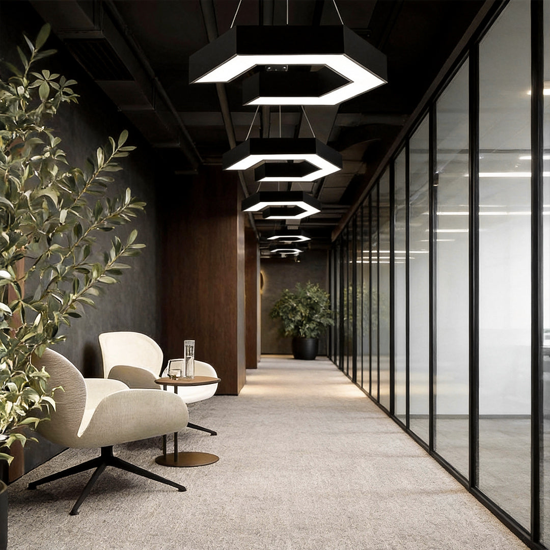 Modern forms chandeliers installed in a glass-partitioned office corridor, showcasing layered geometric LED designs for contemporary interiors.