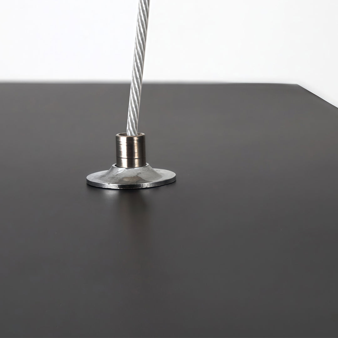 Close-up suspension detail of modern forms chandeliers, highlighting the steel cable and mounting hardware for a clean, minimal look.