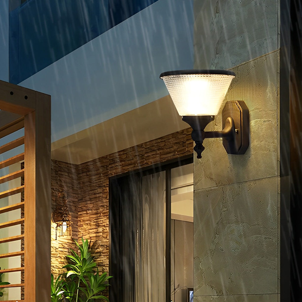 Modern funnel wall light with sleek design illuminating a wooden fence and garden during evening hours.