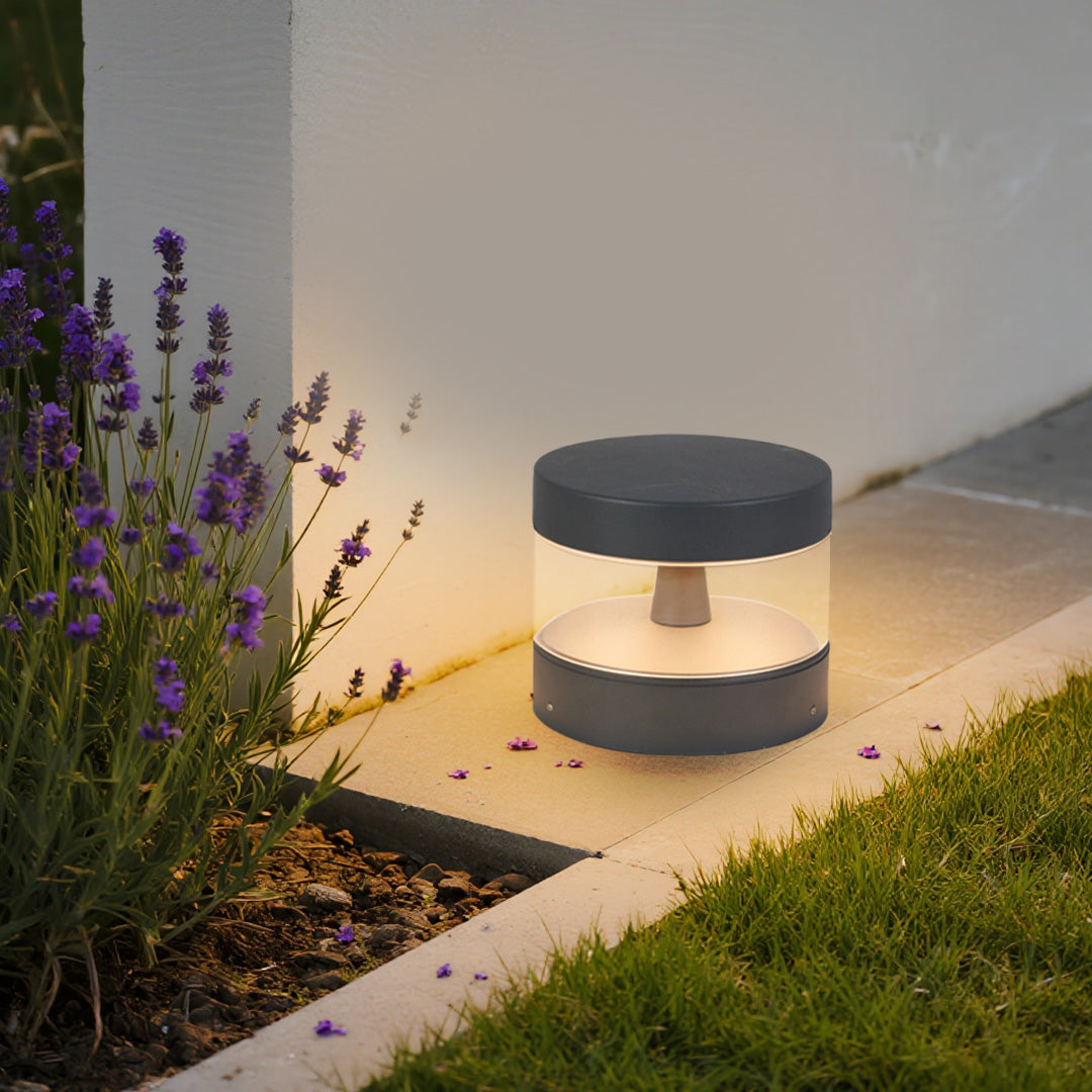 Contemporary path light enhancing modern garden design with purple plantings and clean architectural lines