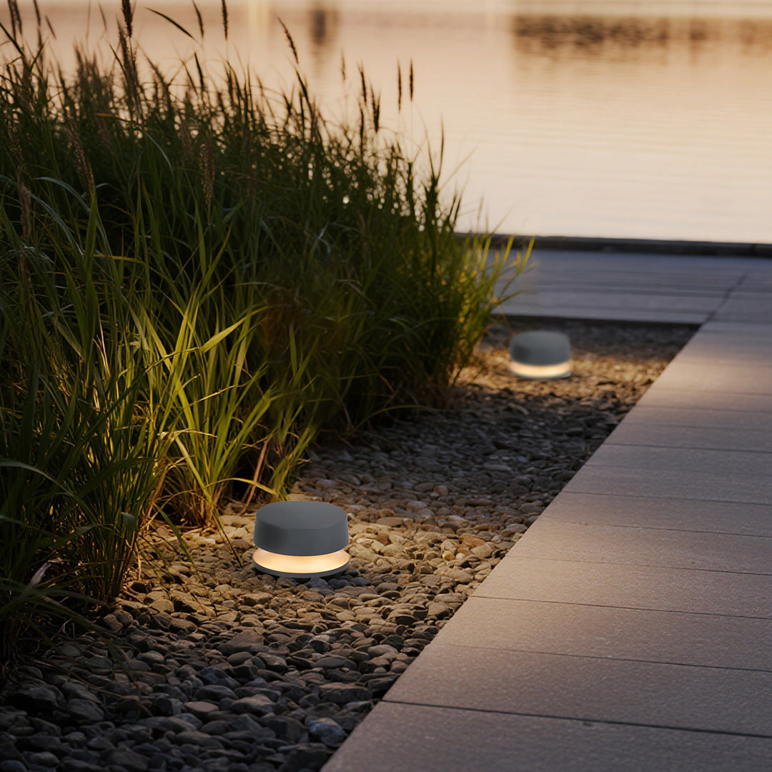 LED outdoor landscape light enhancing modern garden design with ornamental grasses and contemporary hardscaping