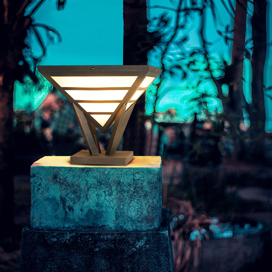 Modern gate pillar light mounted on a concrete post with dramatic night lighting.