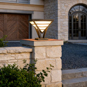 Modern gate pillar light mounted on a stone entrance column.