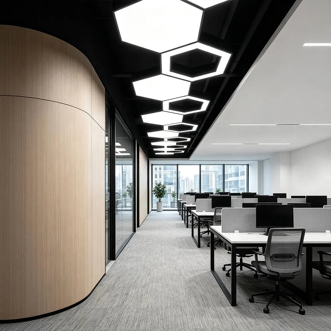Modern geometric chandelier arranged in a linear ceiling layout above a bright office workspace.