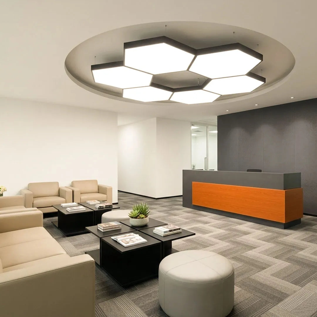 Modern geometric chandelier mounted on the ceiling above a reception lounge with sofas and a front desk.