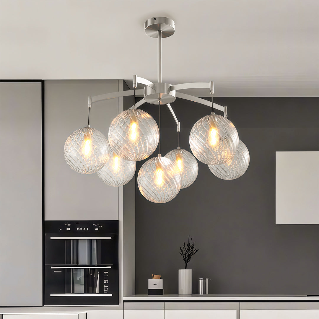 gold modern glass ball chandelier above a round dining table in a stylish dining nook