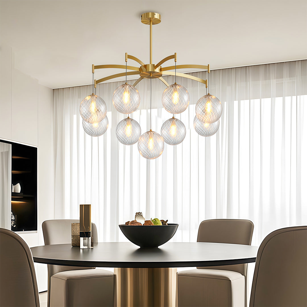 gold modern glass ball chandelier above a round dining table in a stylish dining nook