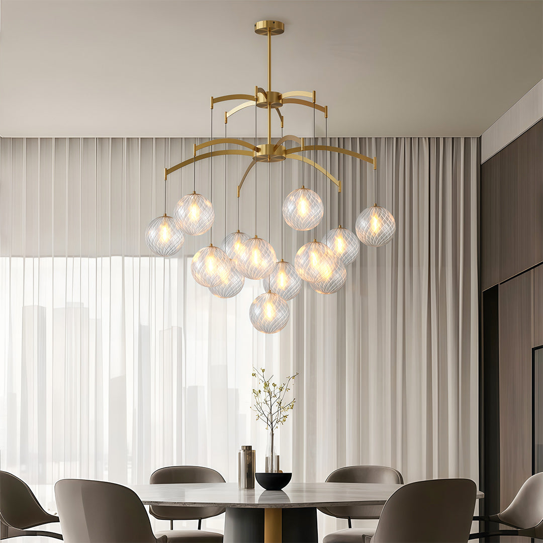 gold modern glass ball chandelier above a round dining table in a stylish dining nook