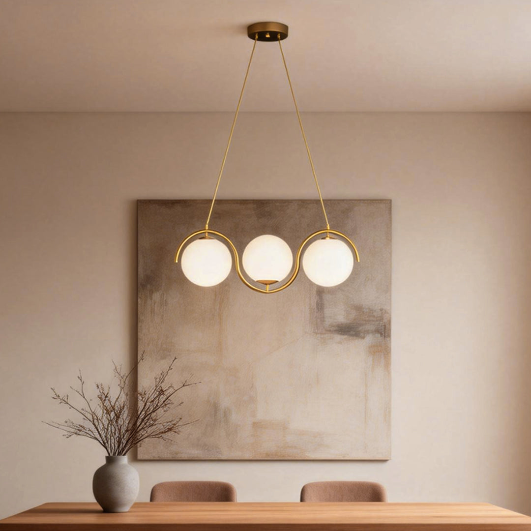 Modern glass ball linear chandelier with sleek gold framework, adding a luxurious and stylish ambiance to the room.
