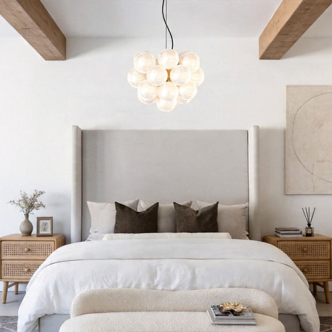 Glass bubble chandelier in bedroom creating soft ambient lighting atmosphere.