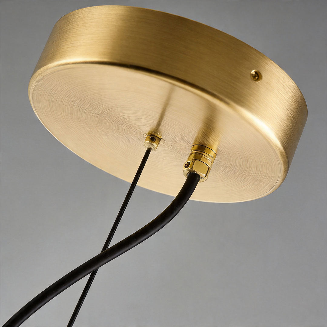 Close-up of brass ceiling mount for modern glass bubble chandelier fixture.