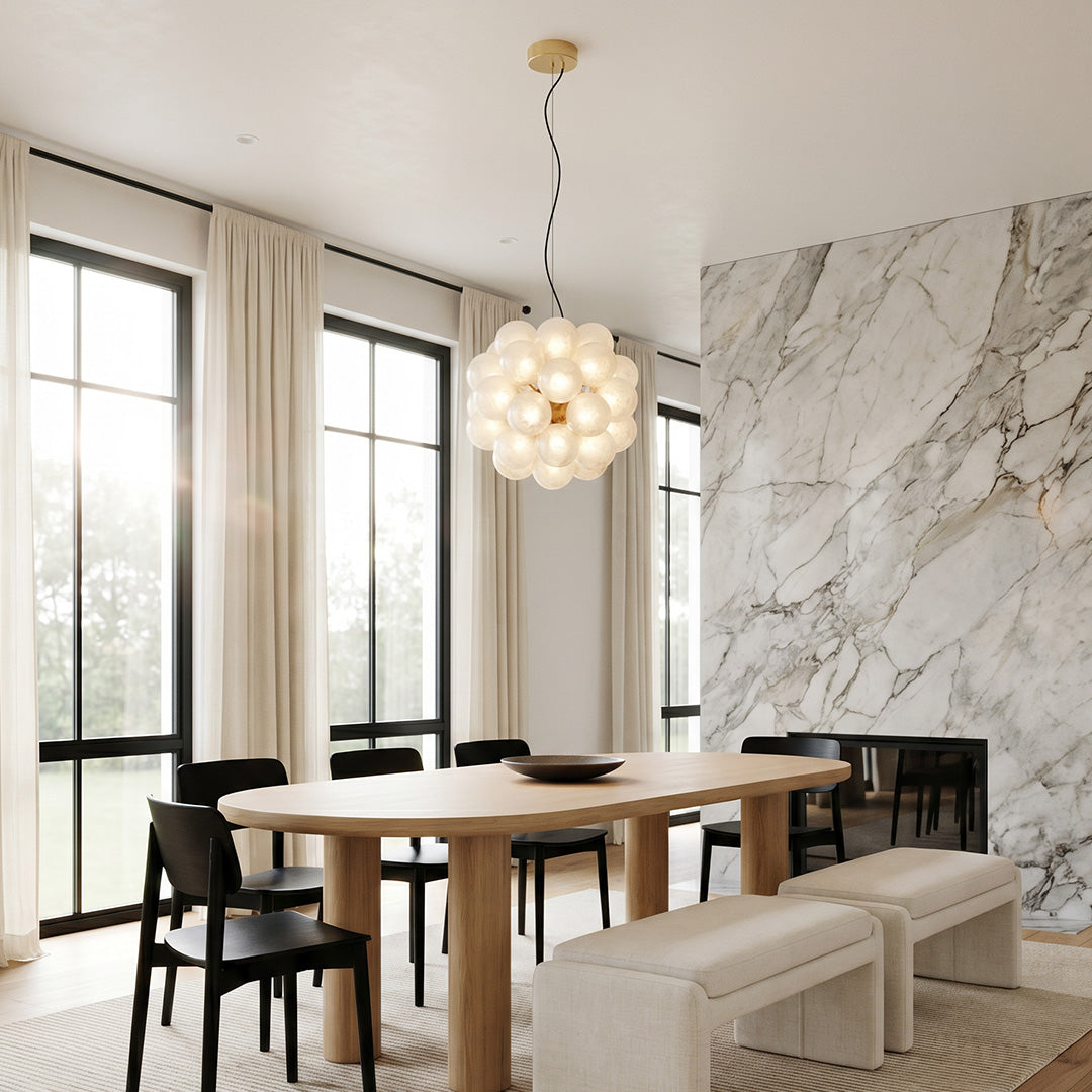 Modern glass bubble chandelier above dining table with minimalist interior design.