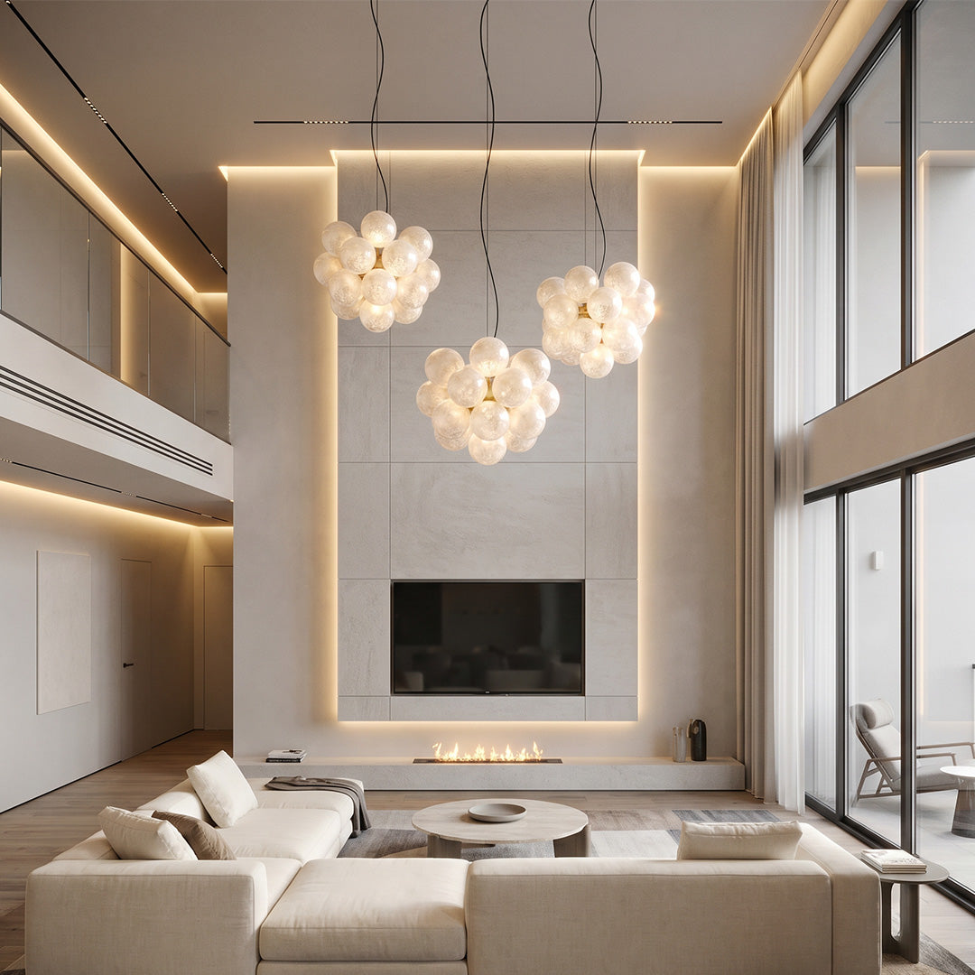 Glass bubble chandelier in high ceiling living space with multiple clustered globes.