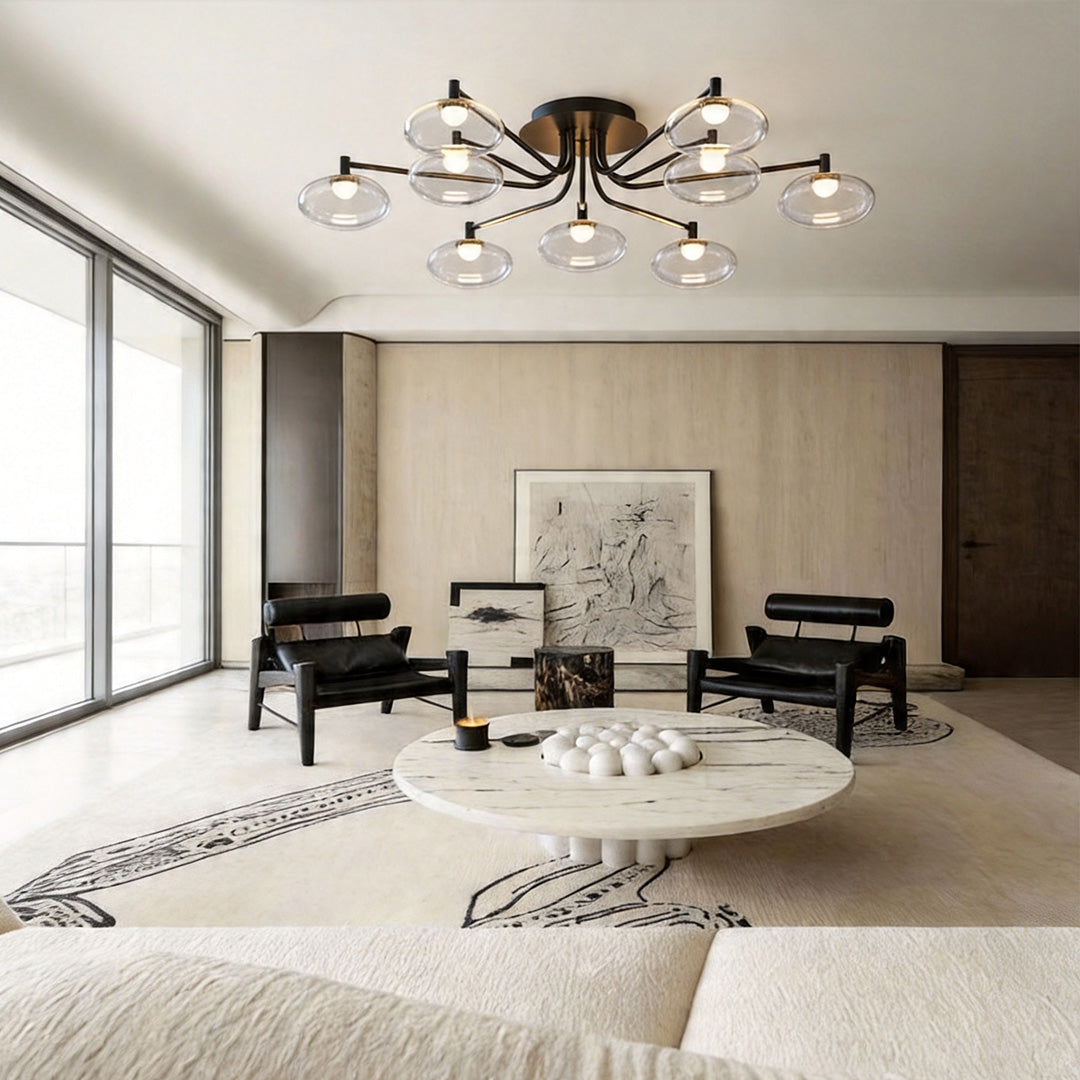 Modern glass flush mount lighting fixture installed in a spacious living room with neutral decor.