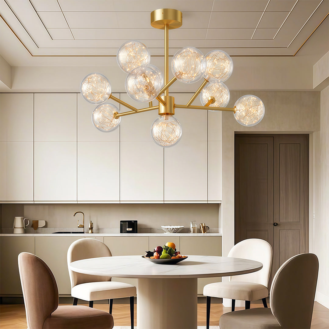 Modern luxury chandeliers illuminating contemporary dining room with round table and neutral chairs