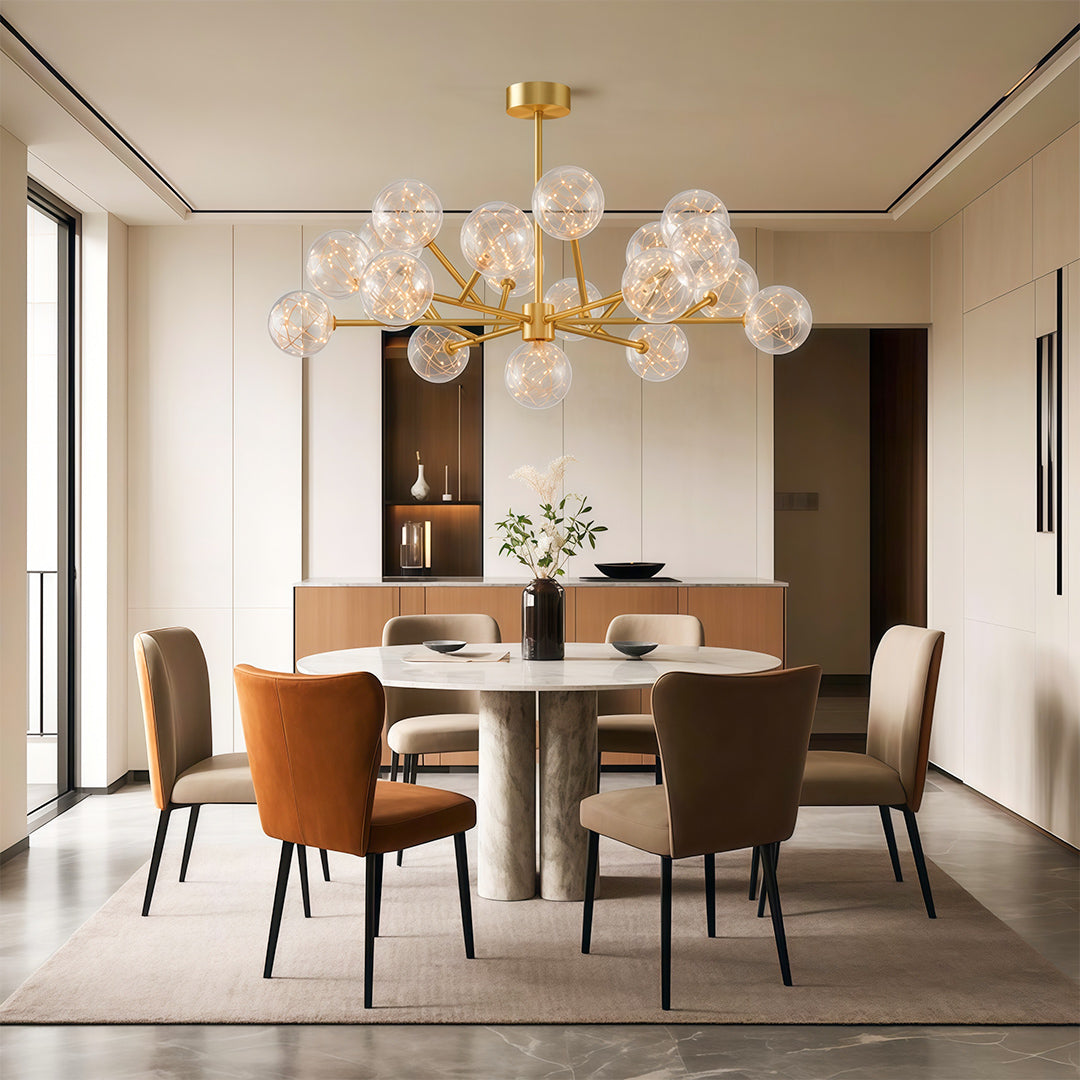 Modern luxury chandeliers creating warm ambiance in elegant dining room with rust chairs