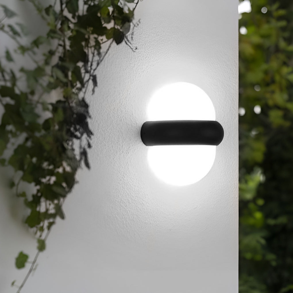 Modern globe wall sconce in black, mounted on a white wall for a sleek and contemporary look.