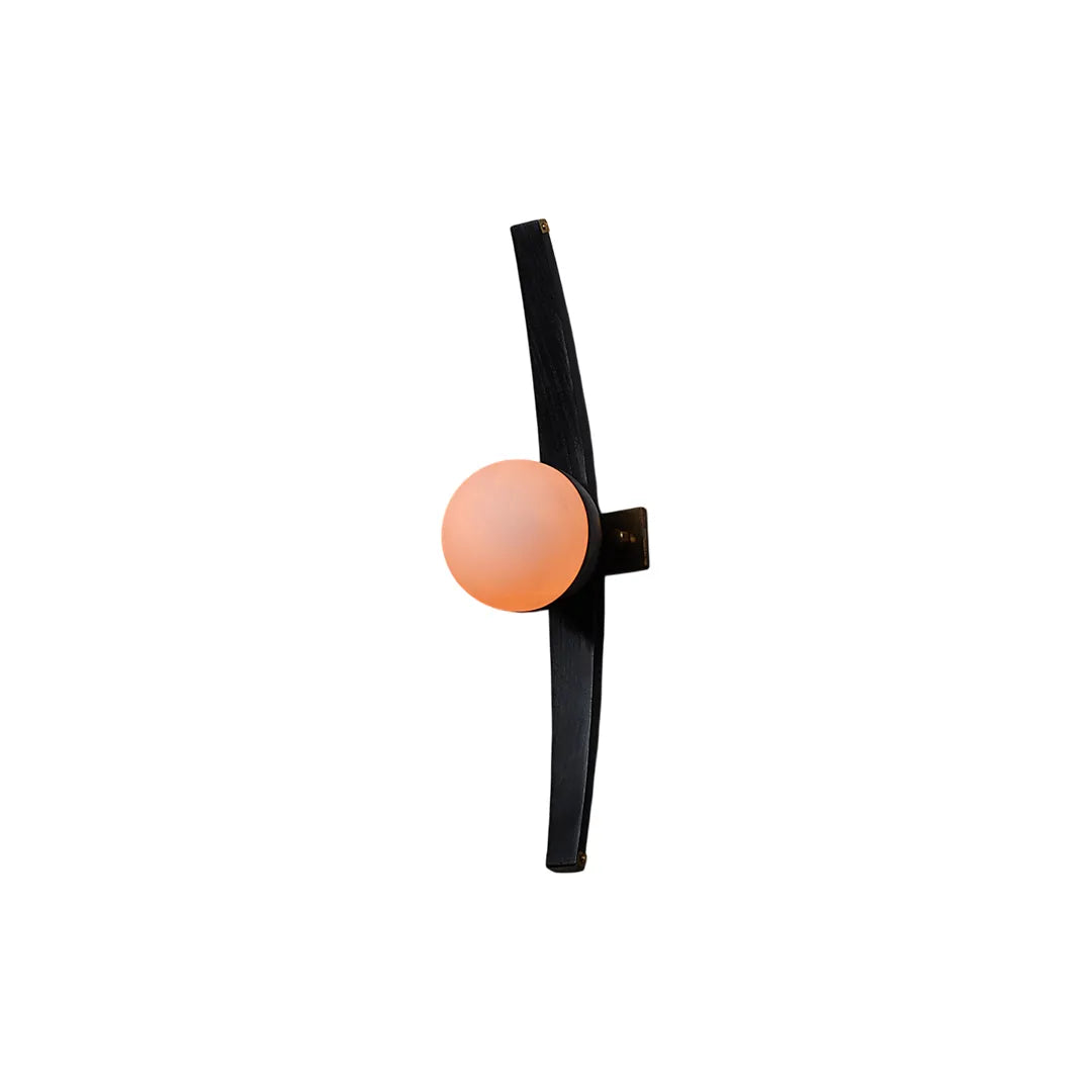 Modern globe wall sconce isolated on a white background with a black curved frame and peach glass globe.