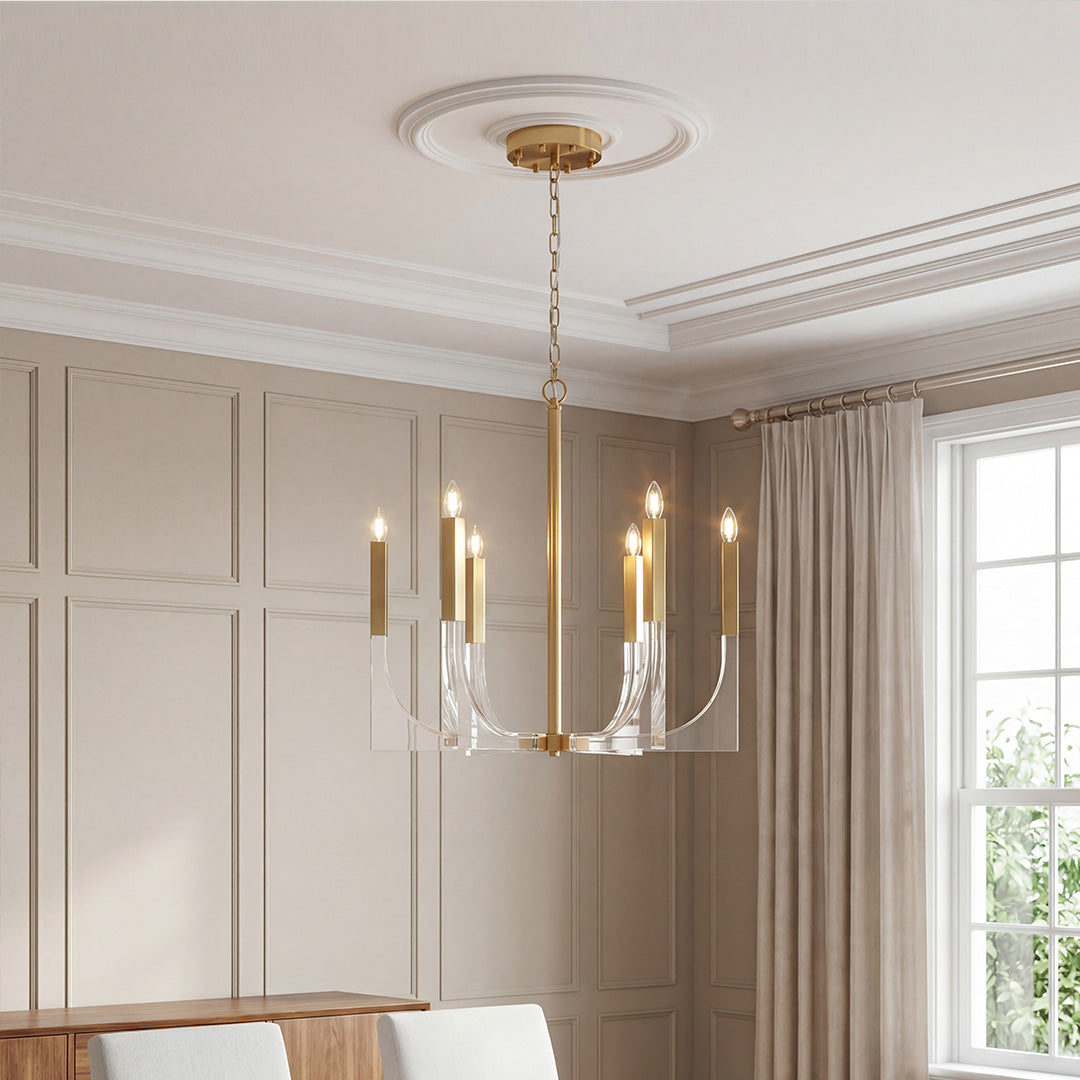 Modern gold acrylic chandeliers with elegant U-shaped arms and sleek candle-style light bulbs.