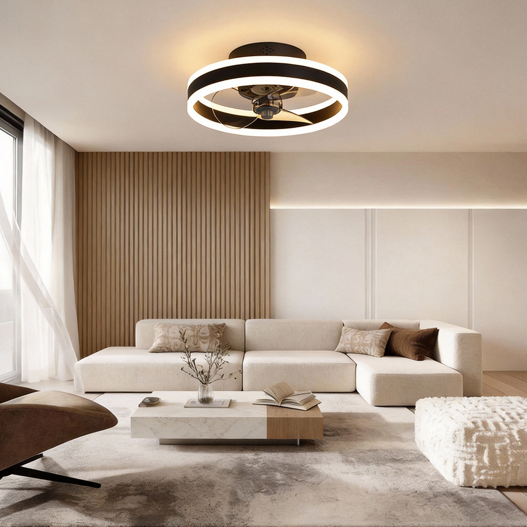 Modern gold ceiling fan with circular LED light in minimalist living room.