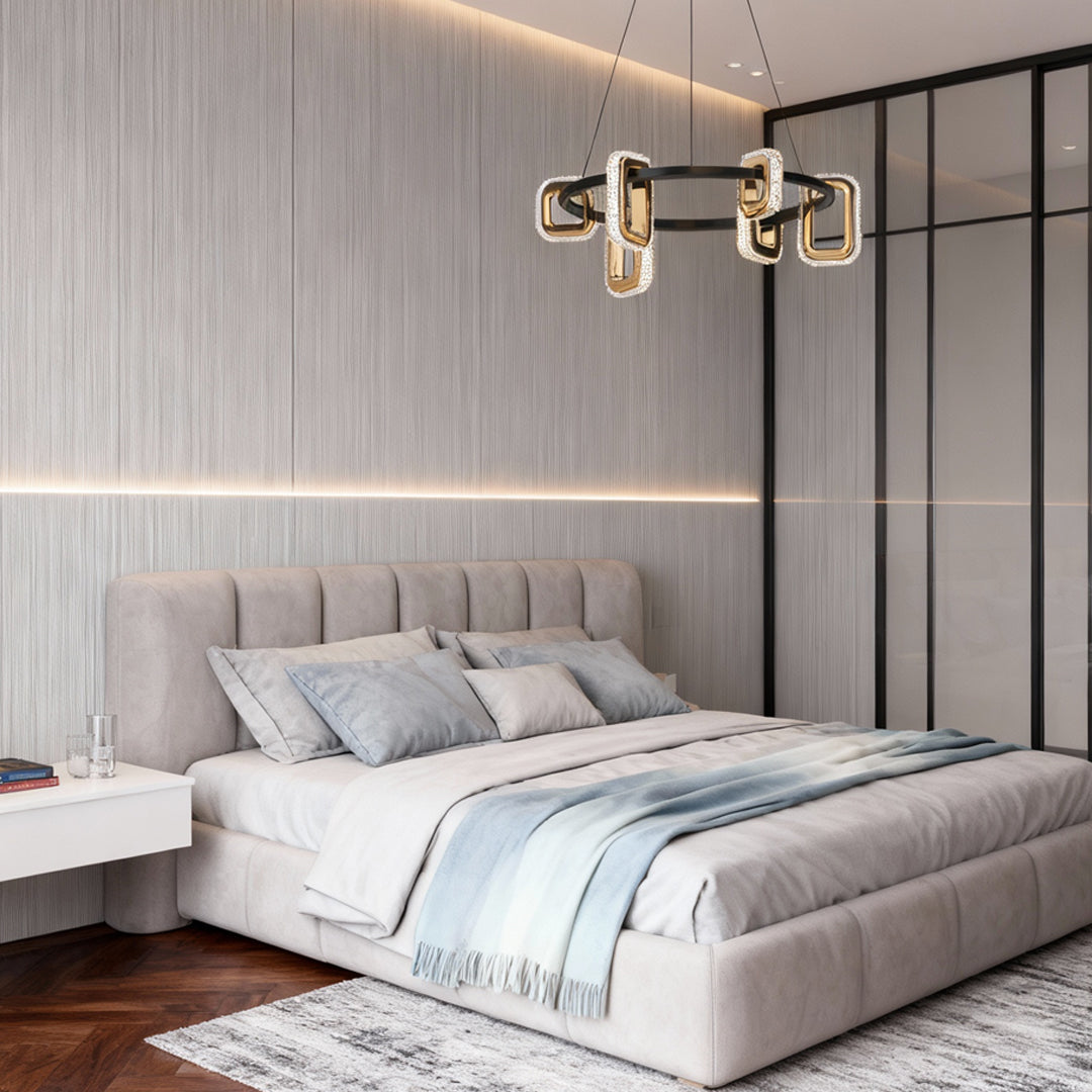 Modern gold chandeliers illuminating contemporary bedroom with tufted gray headboard and minimalist glass partition wall