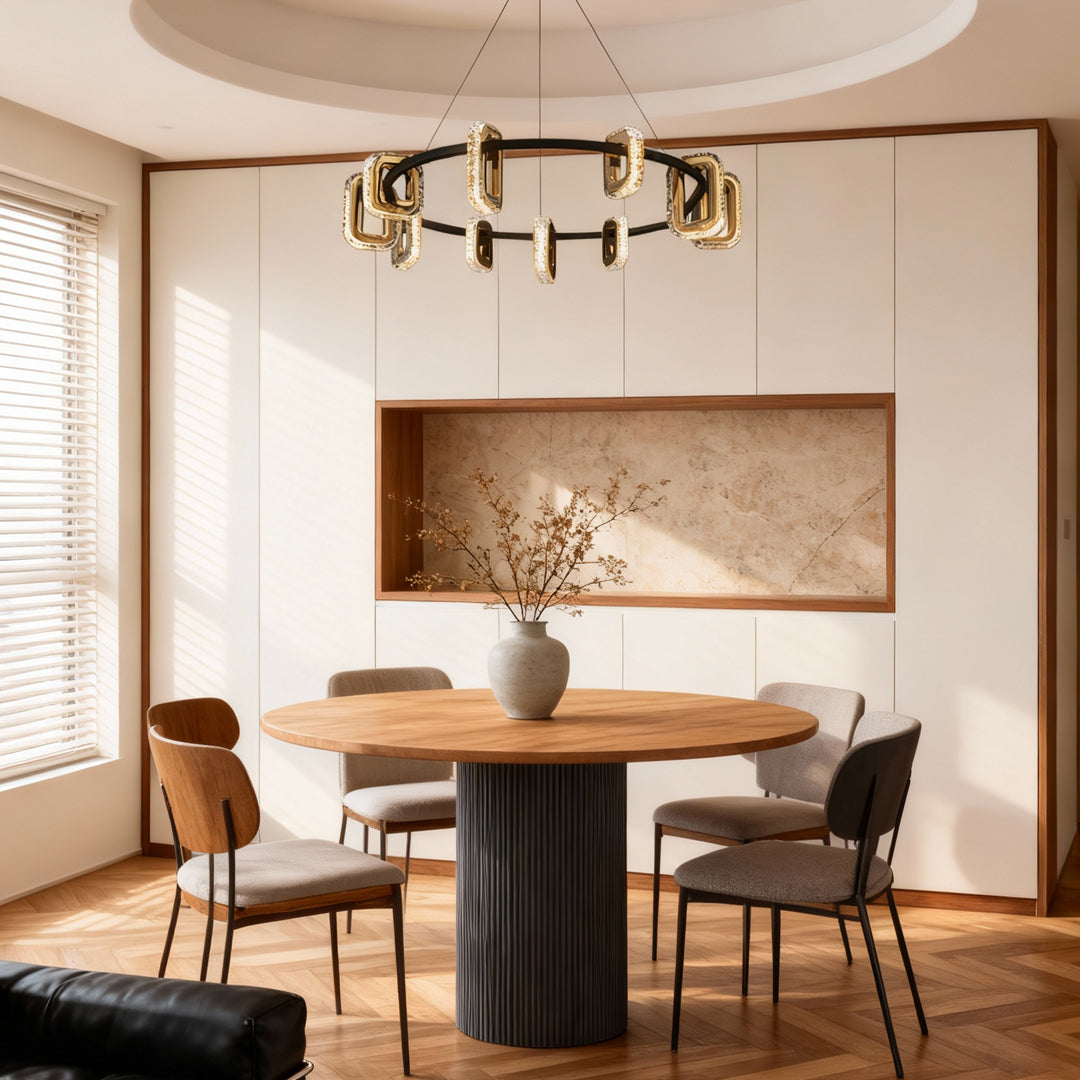 Modern gold chandeliers suspended above dining area with abstract artwork and contemporary furniture in bright space