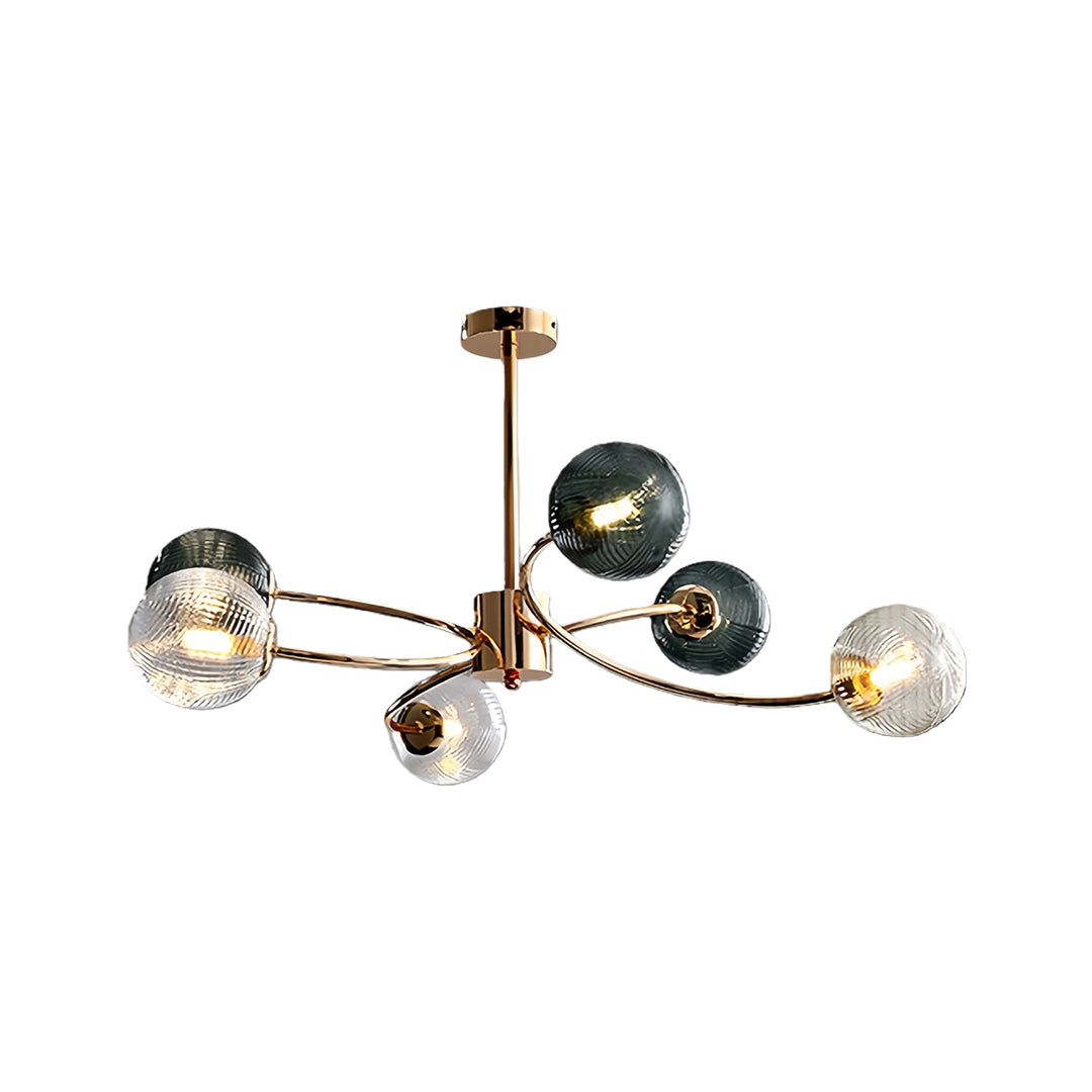 Isolated view of a modern gold and clear glass flush mount ceiling light fixture with multiple smoky green and clear globes.