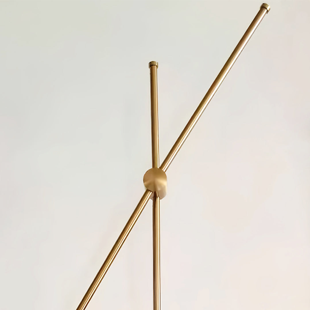 Modern linear wall light with gold finish and spherical bulbs in a stylish living room