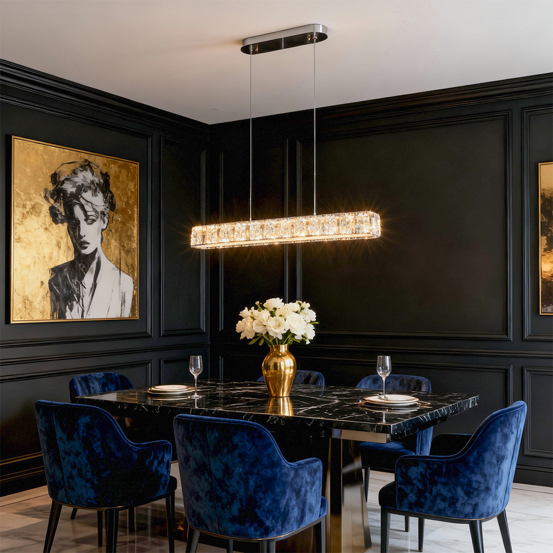 Modern gold pendant light in a dining room with large windows and ocean view, enhancing the ambiance.