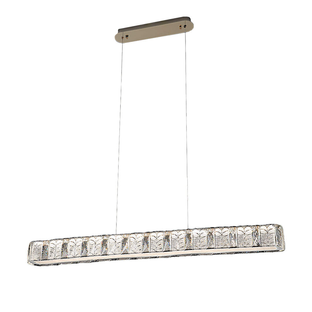 Modern gold pendant light installed above a dining table, providing warm and inviting illumination.