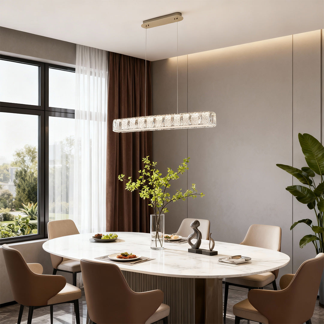 Modern gold pendant light featuring a sleek rectangular frame with crystal accents.