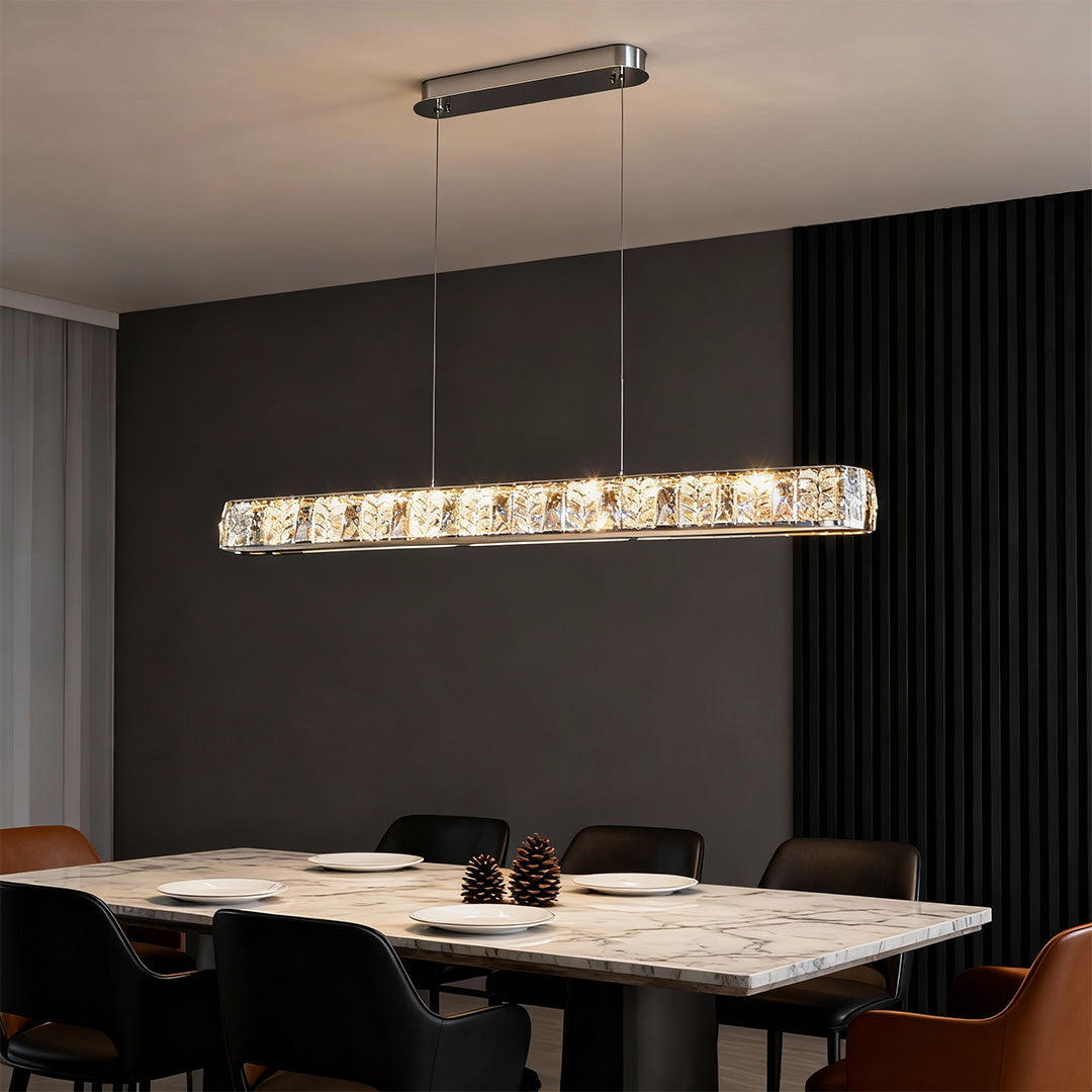 Modern gold pendant light in a sophisticated dining area with blue accents, providing a chic focal point.
