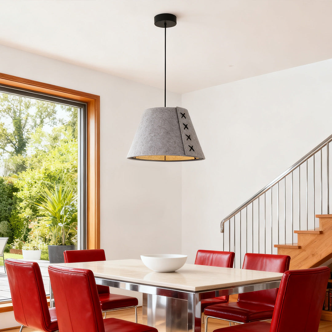 modern grey felt hanging pendant light fixture over a dining room table next to a window 