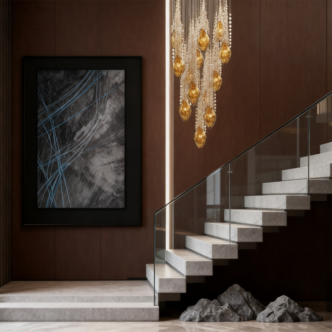 Modern stairway chandelier illuminating a minimalist staircase.
