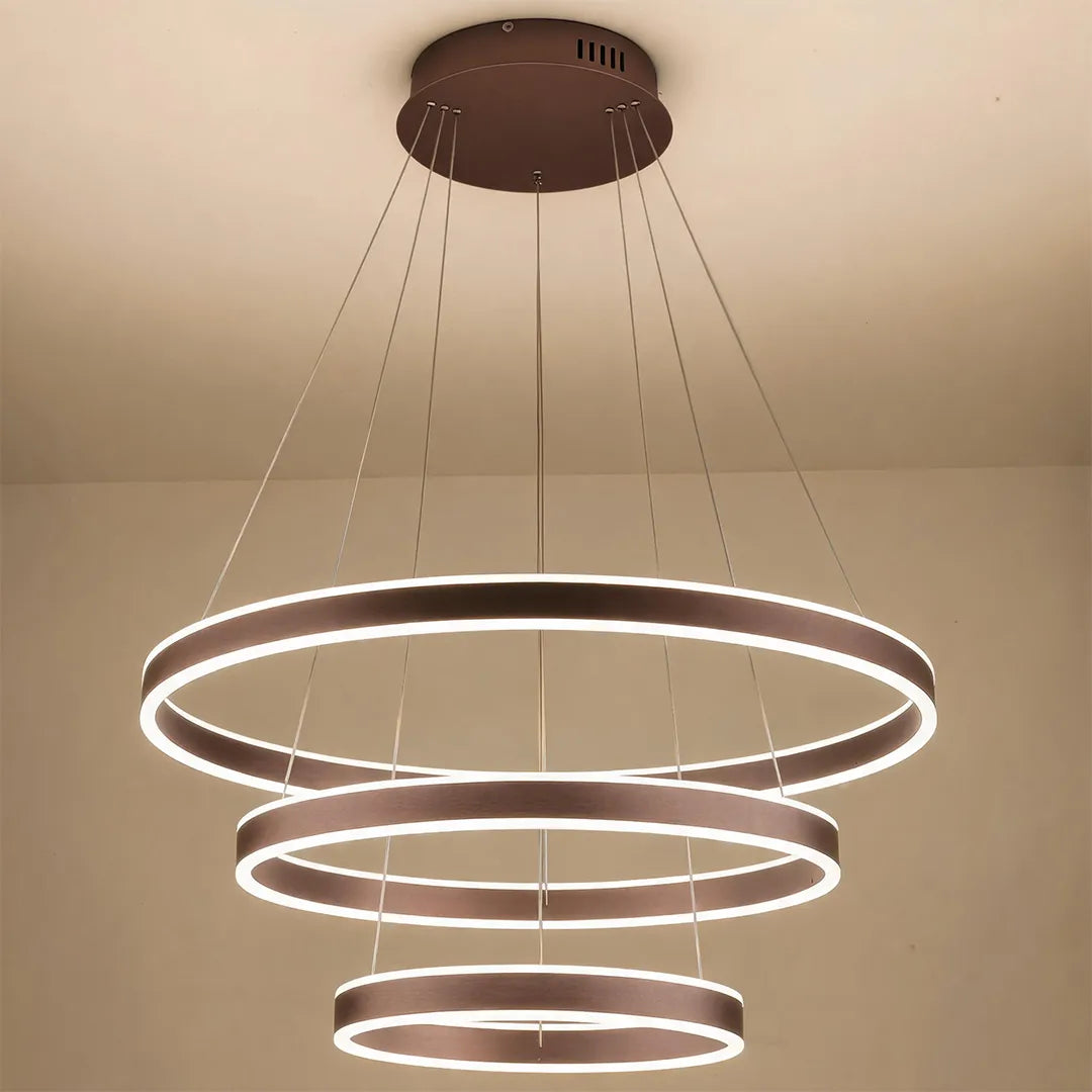 Modern halo chandelier featuring three glowing LED rings suspended from a round ceiling canopy.