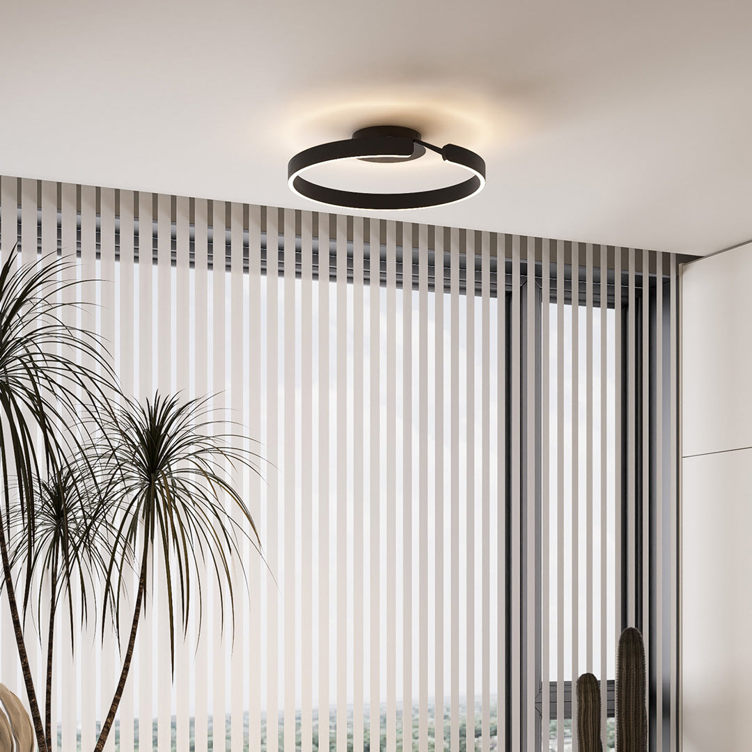 Modern halo flush mount ceiling light with glass shade chandelier styling in black creating striking circular light pattern overhead.
