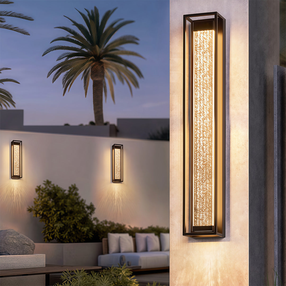 Black outdoor sconces with a textured glass front, enhancing the exterior of a modern home.