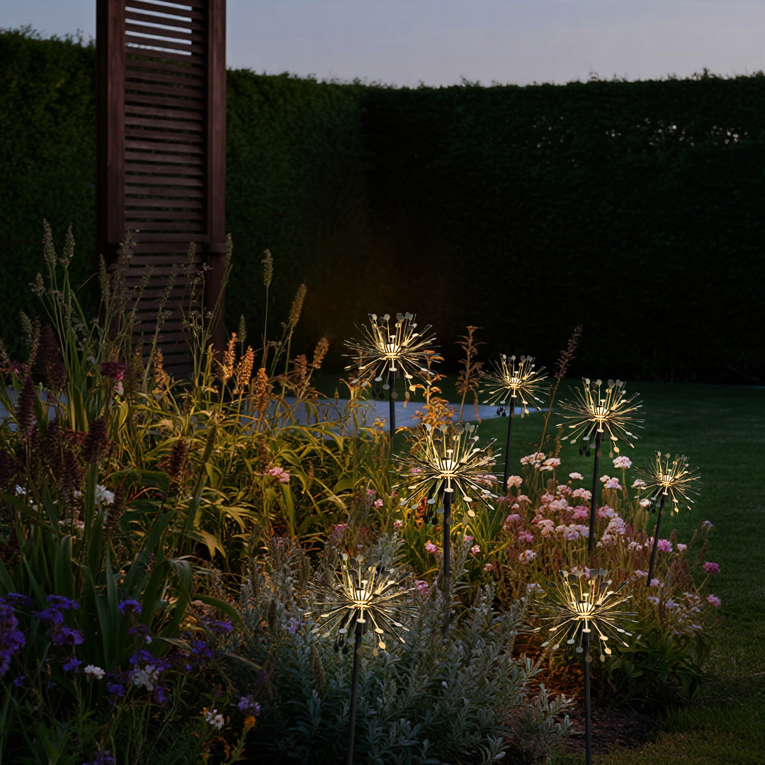 Modern outdoor installation featuring multiple illuminated landscape garden lights with contemporary starburst design
