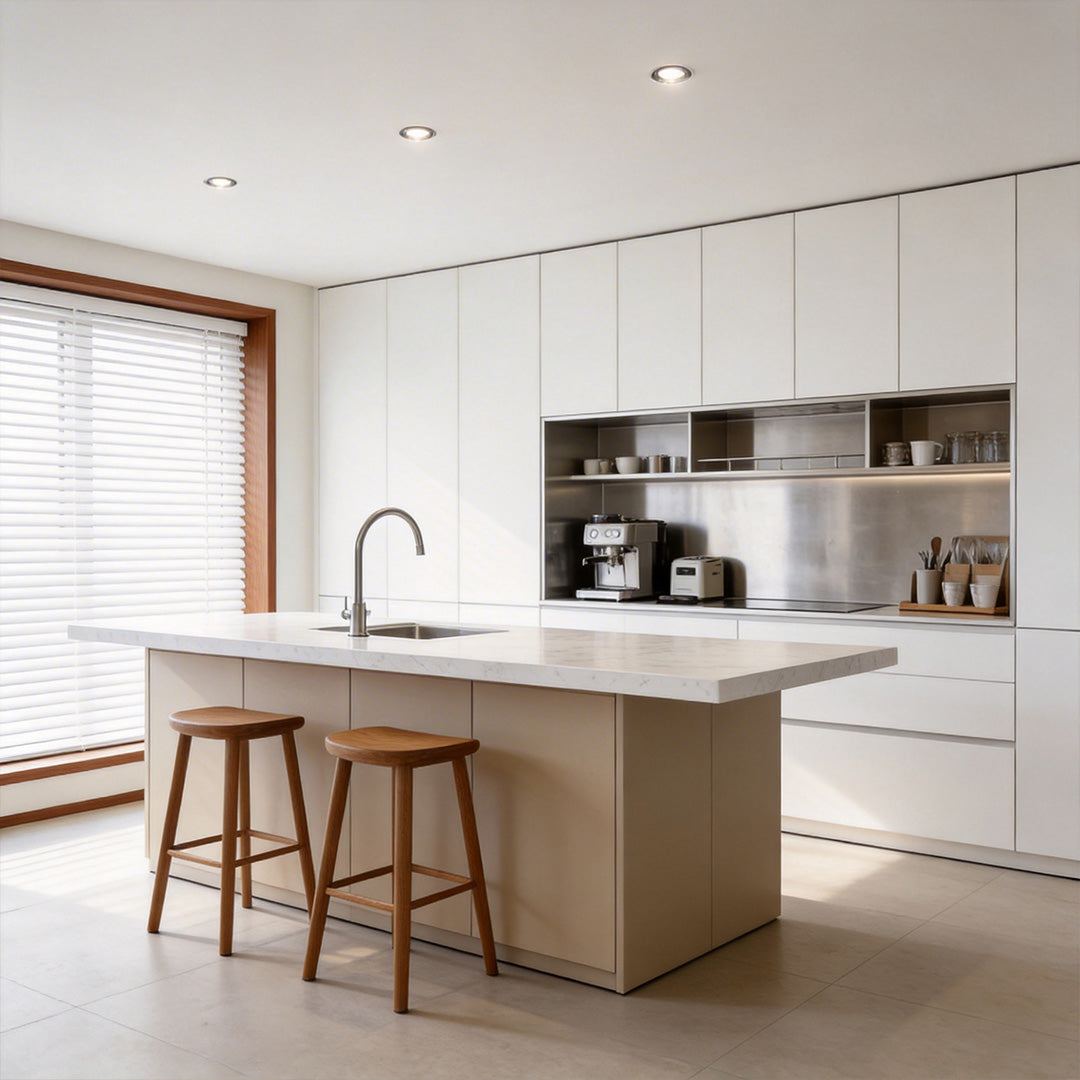 Modern kitchen with recessed ceiling spotlight providing focused lighting over the island.