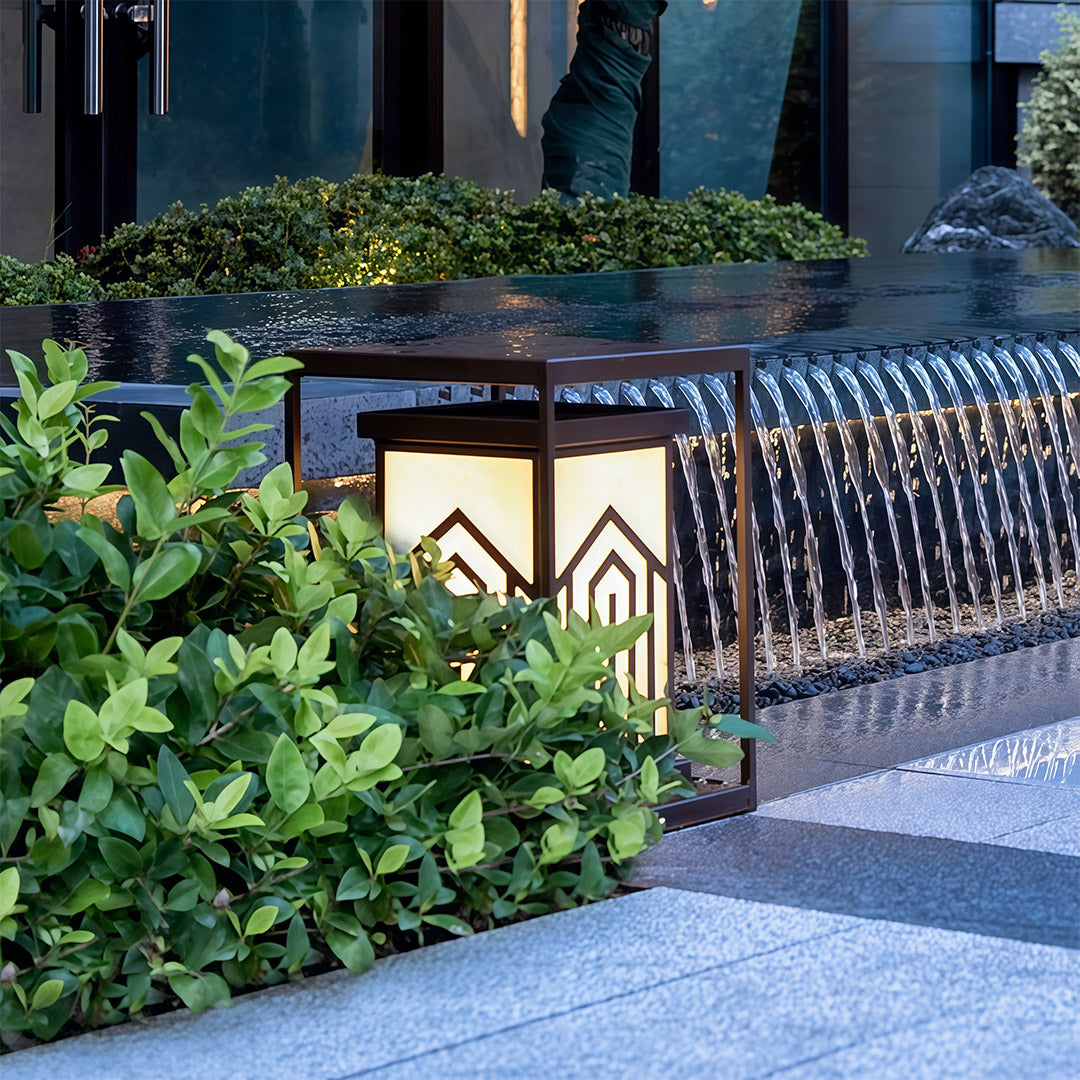 Lantern outdoor lights placed along a modern garden, creating a warm, inviting atmosphere for evening relaxation.