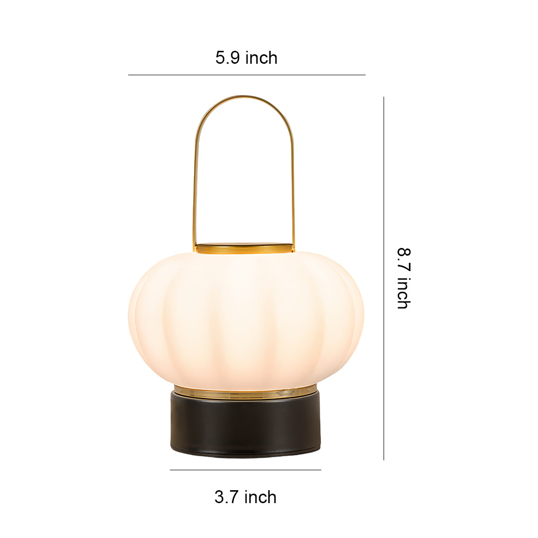 Modern lantern table lamp with ribbed glass shade and brass handle in contemporary design